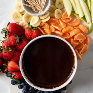 chocolate fondue bowl surrounded by fruit