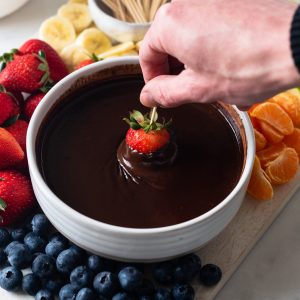 strawberry dipped into chocolate fondue